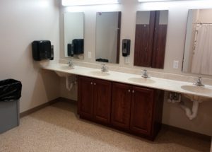 Clean public restroom sinks with mirrors and soap dispensers.